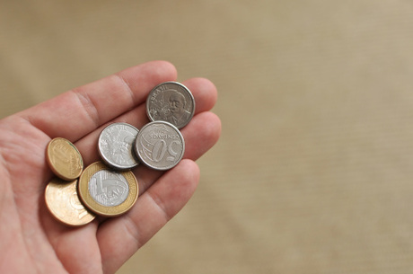 Hand Holding Brazil Coins Currency