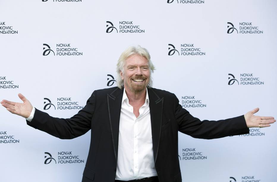 Business entrepreneur Richard Branson poses for photographers as he arrives at a fundraising dinner for the Novak Djokovic Foundation in London July 8, 2013.   REUTERS/Neil Hall   (BRITAIN - Tags: SPORT TENNIS ENTERTAINMENT SOCIETY BUSINESS)