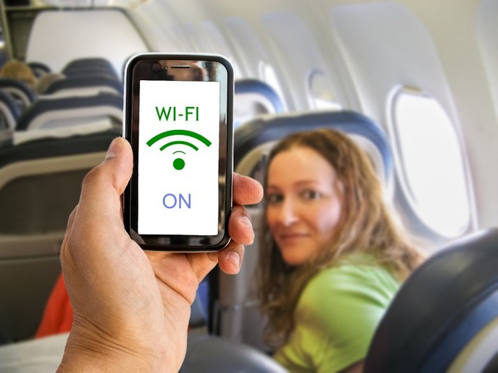 Hand holding mobile smart phone with connect wifi on the airplane